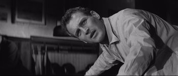 Movie still from “The Hustler” (1961), directed by Robert Rossen – Black and white photograph of a man in a shirt; Close Up shot, Low angle