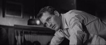 Movie still from “The Hustler” (1961), directed by Robert Rossen – Black and white photograph of a man looking at the camera; Close Up shot, Low angle