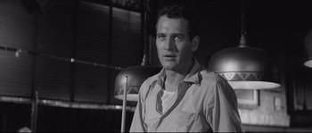 Movie still from “The Hustler” (1961), directed by Robert Rossen – A black - and - white photo of a man in a white shirt; Close Up shot, Low angle