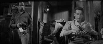 Movie still from “The Hustler” (1961), directed by Robert Rossen – Two men are working in an old - fashioned kitchen; Medium shot, Low angle