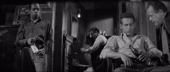 Movie still from “The Hustler” (1961), directed by Robert Rossen – A man in an old time barber shop looking at a mirror; Medium shot, Low angle