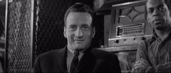 Movie still from “The Hustler” (1961), directed by Robert Rossen – A black and white photo of a man in a suit and tie; Close Up shot, Low angle