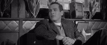 Movie still from “The Hustler” (1961), directed by Robert Rossen – Black and white photograph of a man in a suit and tie; Close Up shot, Over the shoulder angle