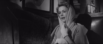 Movie still from “The Hustler” (1961), directed by Robert Rossen – A black - and - white photo of a woman with a scarf around her neck; Close Up shot, Over the shoulder angle