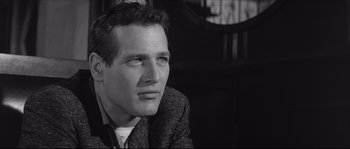 Movie still from “The Hustler” (1961), directed by Robert Rossen – Black and white photograph of a man in a suit; Close Up shot, Over the shoulder angle