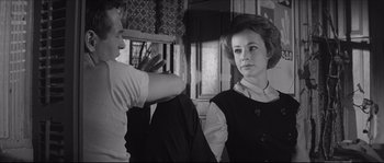 Movie still from “The Hustler” (1961), directed by Robert Rossen – A man and a woman are talking in a room; Medium shot, Over the shoulder angle