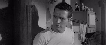 Movie still from “The Hustler” (1961), directed by Robert Rossen – Black and white photograph of a man in a t - shirt; Close Up shot, High angle