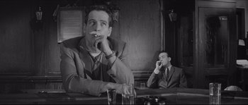 Movie still from “The Hustler” (1961), directed by Robert Rossen – Two men sitting at a table in front of drinks; Medium shot, Low angle