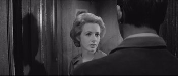 Movie still from “The Hustler” (1961), directed by Robert Rossen – A black and white photo of a woman looking at a man in the mirror; Close Up shot, Over the shoulder angle