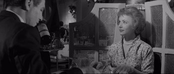Movie still from “The Hustler” (1961), directed by Robert Rossen – A black and white photo of a woman sitting at a table; Close Up shot, Over the shoulder angle