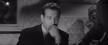 Movie still from “The Hustler” (1961), directed by Robert Rossen – A black and white photo of a man in a suit; Close Up shot, Over the shoulder angle