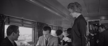 Movie still from “The Hustler” (1961), directed by Robert Rossen – A man and a woman sitting at a table in front of another man; Medium shot, Low angle