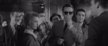 Movie still from “The Hustler” (1961), directed by Robert Rossen – A group of people standing next to each other in a room; Medium shot, Low angle