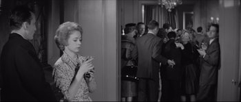 Movie still from “The Hustler” (1961), directed by Robert Rossen – A black and white photo of a woman holding a cell phone; Medium shot, High angle