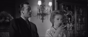 Movie still from “The Hustler” (1961), directed by Robert Rossen – An older woman and a younger man are drinking wine together; Medium shot, Low angle