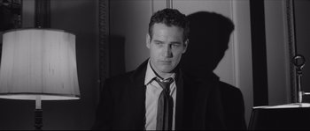 Movie still from “The Hustler” (1961), directed by Robert Rossen – Black and white photograph of a man wearing a suit and tie; Close Up shot, Low angle