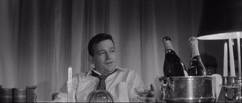 Movie still from “The Hustler” (1961), directed by Robert Rossen – A black and white photo of a man holding a wine glass; Close Up shot, Low angle