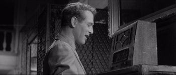 Movie still from “The Hustler” (1961), directed by Robert Rossen – A black - and - white photo of a man playing the piano; Close Up shot, Low angle