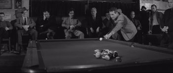 Movie still from “The Hustler” (1961), directed by Robert Rossen – A group of men playing a game of billiards; Medium shot, High angle