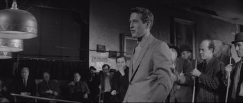 Movie still from “The Hustler” (1961), directed by Robert Rossen – Black and white photograph of a man in a suit; Medium shot, Over the shoulder angle