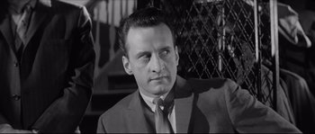 Movie still from “The Hustler” (1961), directed by Robert Rossen – A black and white photo of a man in a suit and tie; Close Up shot, Low angle