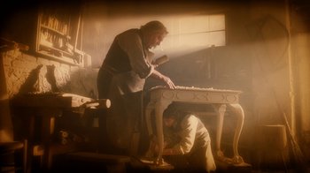 Movie still from “The Illusionist” (2006), directed by Neil Burger – A man and a woman working in a room; Wide shot, High angle