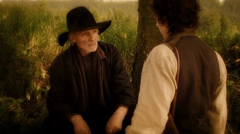 Movie still from “The Illusionist” (2006), directed by Neil Burger – An old man wearing a black hat talking to a young man; Medium shot, Over the shoulder angle