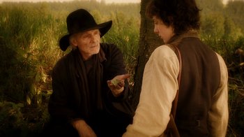 Movie still from “The Illusionist” (2006), directed by Neil Burger – A man and a woman sitting next to a tree; Medium shot, Over the shoulder angle