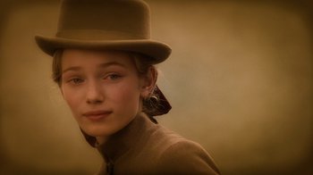 Movie still from “The Illusionist” (2006), directed by Neil Burger – A young woman wearing a hat and a jacket; Close Up shot, Over the shoulder angle