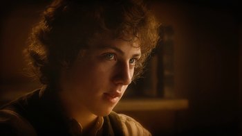 Movie still from “The Illusionist” (2006), directed by Neil Burger – A person's face in the dark; Close Up shot, Low angle