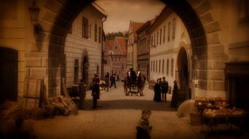 Movie still from “The Illusionist” (2006), directed by Neil Burger – An image of people walking down the street with horse and carriages; Extreme Wide shot, High angle