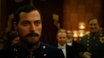 Movie still from “The Illusionist” (2006), directed by Neil Burger – A person wearing a suit and tie; Close Up shot, Over the shoulder angle