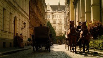 Movie still from “The Illusionist” (2006), directed by Neil Burger – A horse drawn carriage traveling down a narrow street; Wide shot, High angle