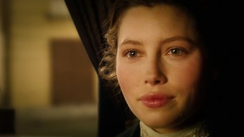 Movie still from “The Illusionist” (2006), directed by Neil Burger – A woman's face in a dark room; Close Up shot, Over the shoulder angle