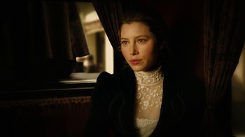 Movie still from “The Illusionist” (2006), directed by Neil Burger – A woman wearing a black jacket and a white blouse; Close Up shot, Low angle