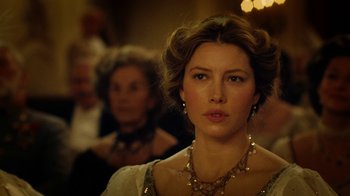 Movie still from “The Illusionist” (2006), directed by Neil Burger – A beautiful woman wearing a dress and a necklace; Close Up shot, Over the shoulder angle