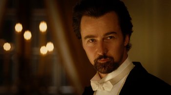 Movie still from “The Illusionist” (2006), directed by Neil Burger – A person wearing a suit and bow tie; Close Up shot, Low angle