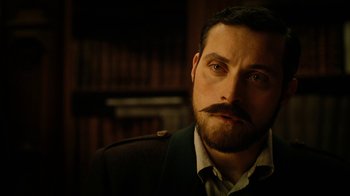 Movie still from “The Illusionist” (2006), directed by Neil Burger – A person with a mustache; Close Up shot, Low angle