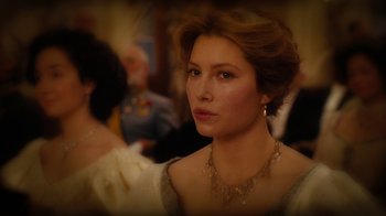 Movie still from “The Illusionist” (2006), directed by Neil Burger – A beautiful woman wearing a white dress and wearing a necklace; Close Up shot, Over the shoulder angle