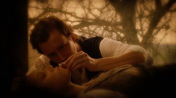 Movie still from “The Illusionist” (2006), directed by Neil Burger – A man and a woman are kissing on a bed; Extreme Close Up shot, Low angle