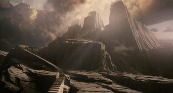 Movie still from “The Imaginarium of Doctor Parnassus” (2009), directed by Terry Gilliam – An image of a mountain with a waterfall in the middle of it; Extreme Wide shot, High angle
