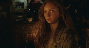 Movie still from “The Imaginarium of Doctor Parnassus” (2009), directed by Terry Gilliam – A woman with long red hair is looking at the camera; Close Up shot, Low angle
