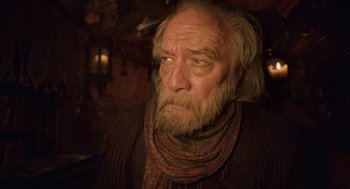 Movie still from “The Imaginarium of Doctor Parnassus” (2009), directed by Terry Gilliam – An old man with a beard and a scarf; Close Up shot, Low angle