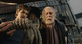 Movie still from “The Imaginarium of Doctor Parnassus” (2009), directed by Terry Gilliam – A man and a young boy holding on to a rope; Close Up shot, Low angle