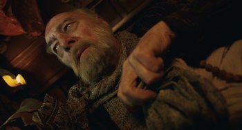 Movie still from “The Imaginarium of Doctor Parnassus” (2009), directed by Terry Gilliam – An old man with a long white beard; Close Up shot, Overhead angle