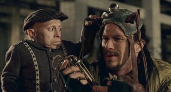 Movie still from “The Imaginarium of Doctor Parnassus” (2009), directed by Terry Gilliam – Two men in medieval garb are looking at each other's hair; Close Up shot, Over the shoulder angle