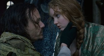 Movie still from “The Imaginarium of Doctor Parnassus” (2009), directed by Terry Gilliam – A man and a woman face to face in a forest; Close Up shot, High angle