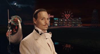 Movie still from “The Imaginarium of Doctor Parnassus” (2009), directed by Terry Gilliam – A man in a white suit standing in front of a neon sign; Close Up shot, Over the shoulder angle