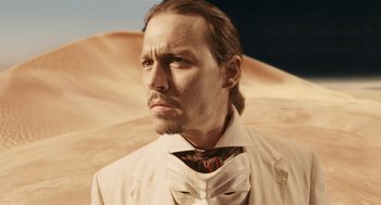 Movie still from “The Imaginarium of Doctor Parnassus” (2009), directed by Terry Gilliam – A person wearing a suit and tie; Close Up shot, Low angle