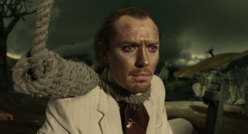 Movie still from “The Imaginarium of Doctor Parnassus” (2009), directed by Terry Gilliam – A person wearing a suit and tie; Close Up shot, Low angle